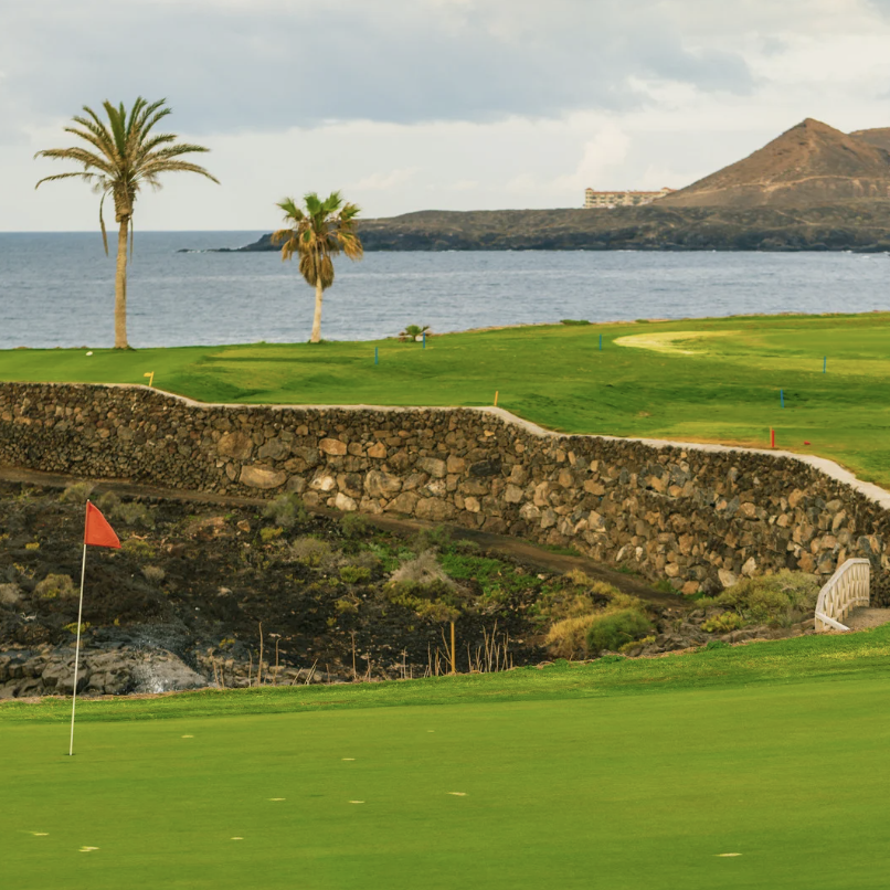 A golf course with a sea view.